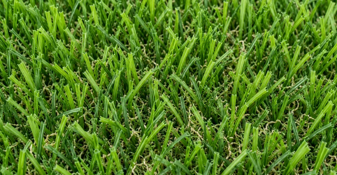 Primer plano de fibras de césped artificial verde