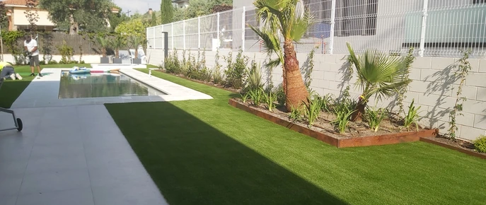 Franja de plantas y grava separada del césped por un perfil